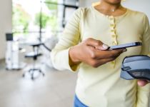 Person filling out form on clipboard