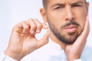 Man holding his knocked-out tooth